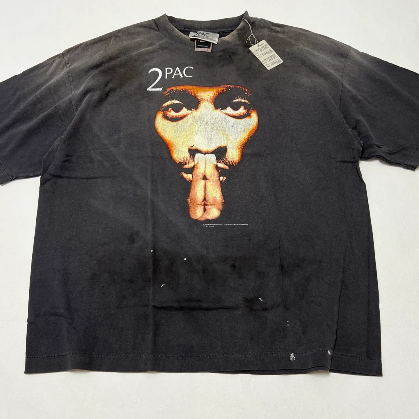 Details SAINT Mxxxxxx × 2PAC 2PC_SS TEE/2PAC/BLK 2PAC co-branded model 2PAC character TEE washed black S-XL A blockbuster co-branded project by the legendary hip-hop artist 2PAC The printing part refers to the iconic graphics on the cover of 2PAC's albums "R U Still Down" and "Shakur" The entire garment is rewashed and distressed/hole-printed The ceiling of New Vintage is a must-have